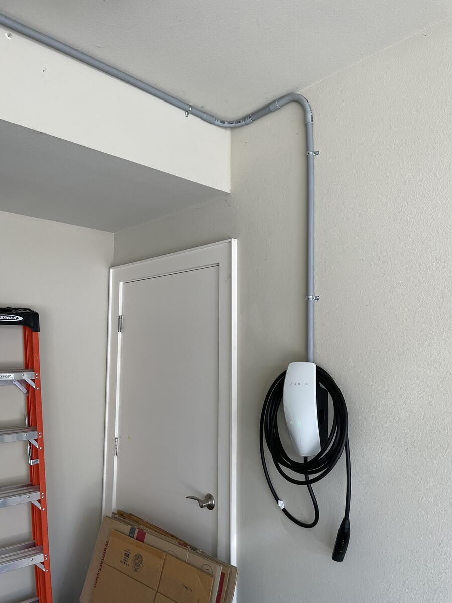 Tesla Wall Connector installation with conduit run in garage